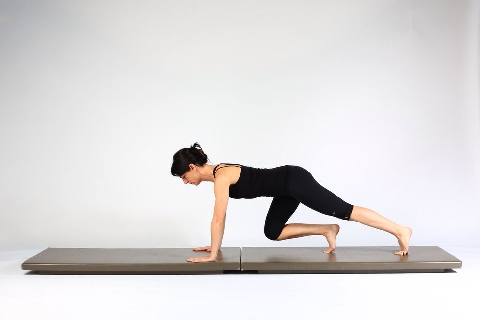4. PLANK WALK OUTS-  Flex right knee and hip knee and hip  returning foot to its start position.