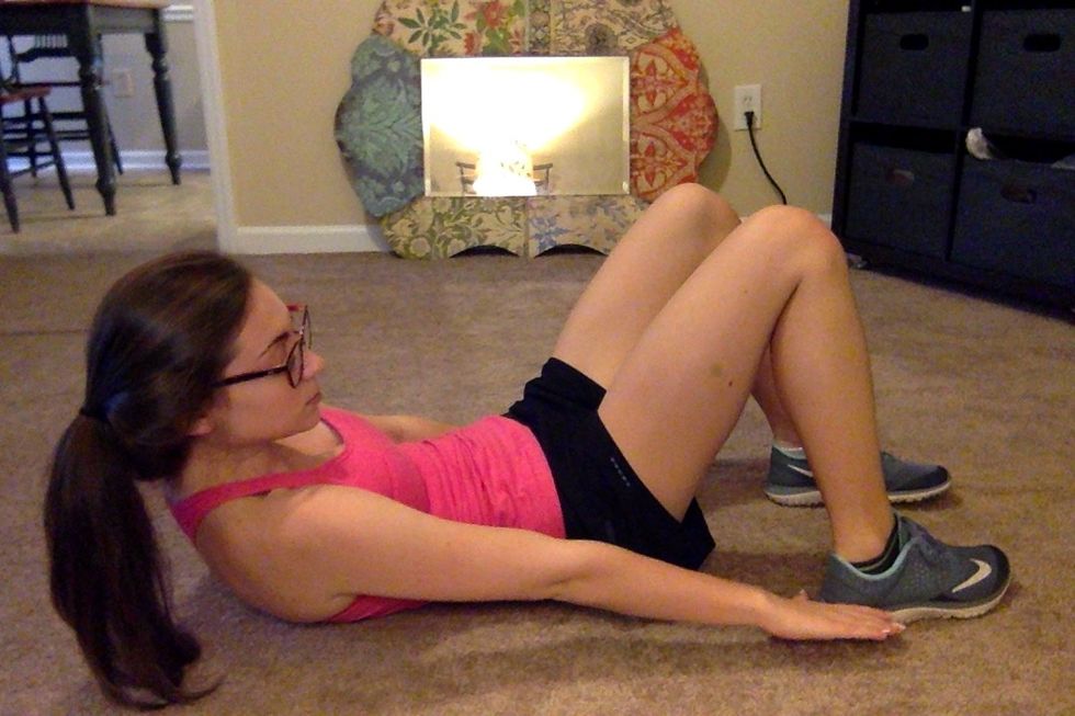 40 Side-to-Side Sneaker Taps: Start in a basic crunch position: Holding that contracted crunch position, rotate side to side, tapping your left sneakers with your left hand