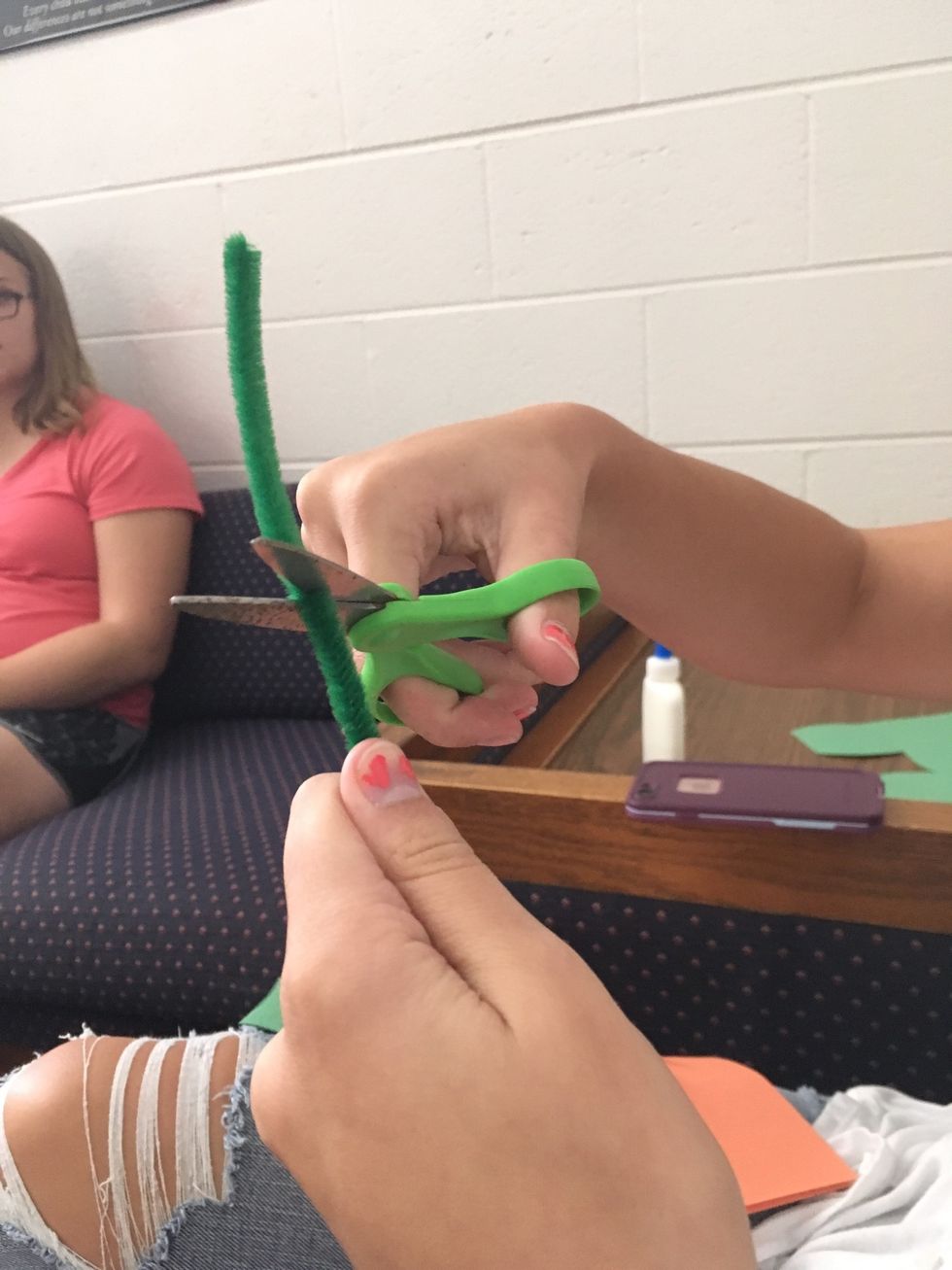 5. Cut the green pipe cleaner in half.