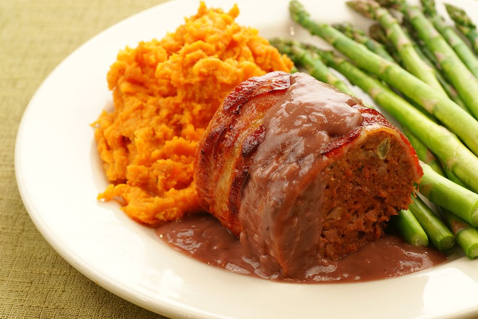 5. Elevate Your Meat and Potatoes: Take your meat and potatoes to a new level with a bacon-wrapped meatloaf and mashed sweet potatoes. (Image via Getty)