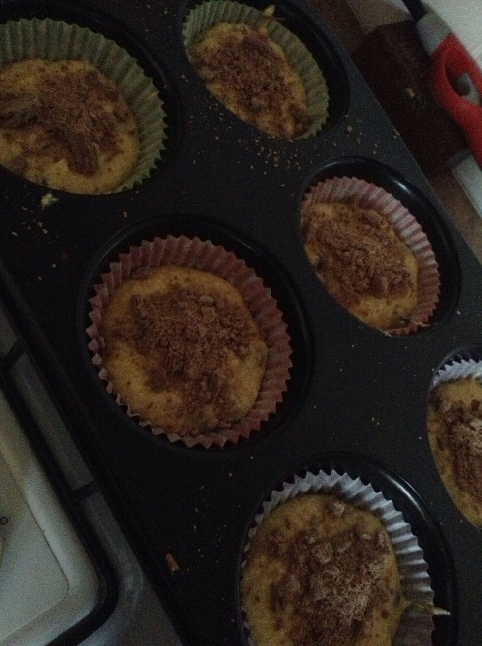 5.) Once the mixture is in the holders, crumble bits of flake on top of each cupcake, about one for each cupcake