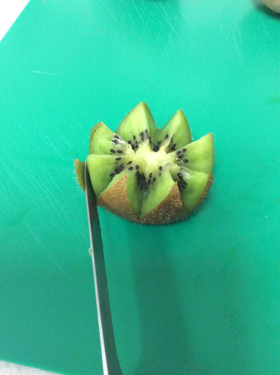 5. With a sharp serrated knife, peel the skin slowly off to create the petals (don't cut all the way down)