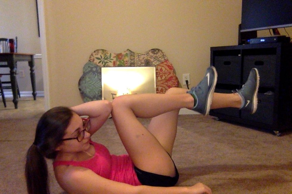 50 Bicycle Crunches: Lay on back, hands behind head, When you crunch up towards your bent left knee, your right leg should be extended out and not touching the ground