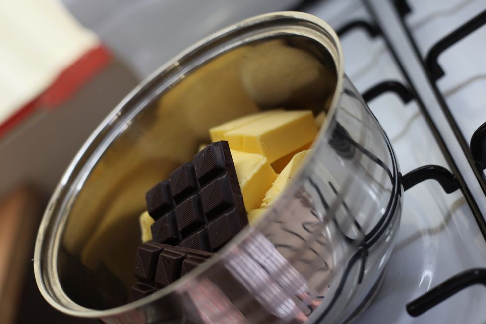 500 gms of unsalted butter 150 gms of dark cooking chocolate. You can use normal chocolate but be careful, you can't melt this way with normal choc. Nice shorts in the reflection!
