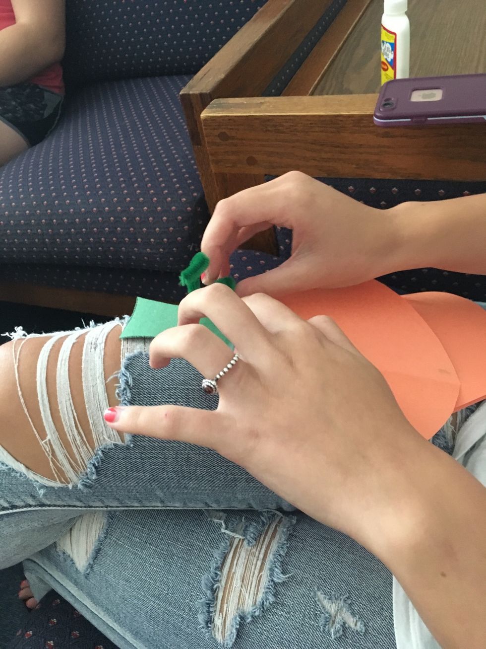 6. Glue the pipe cleaners to the top of the pumpkin to make the vines.