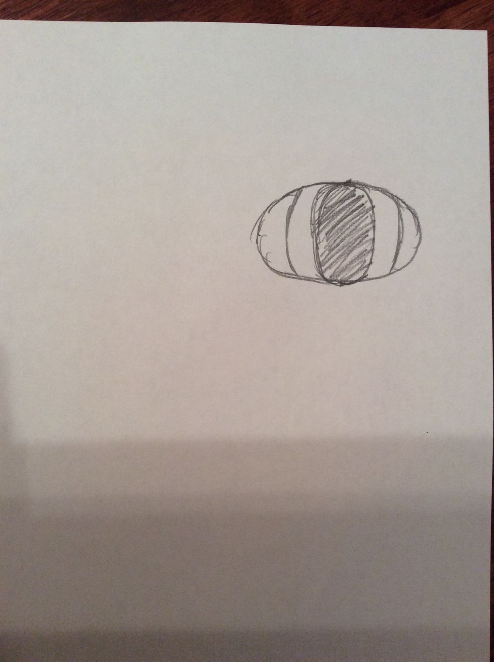 6. Now in between the two, curved lines that you have drawn in the previous step draw an oval measuring 1cm in width, colour in the oval that you have drawn.