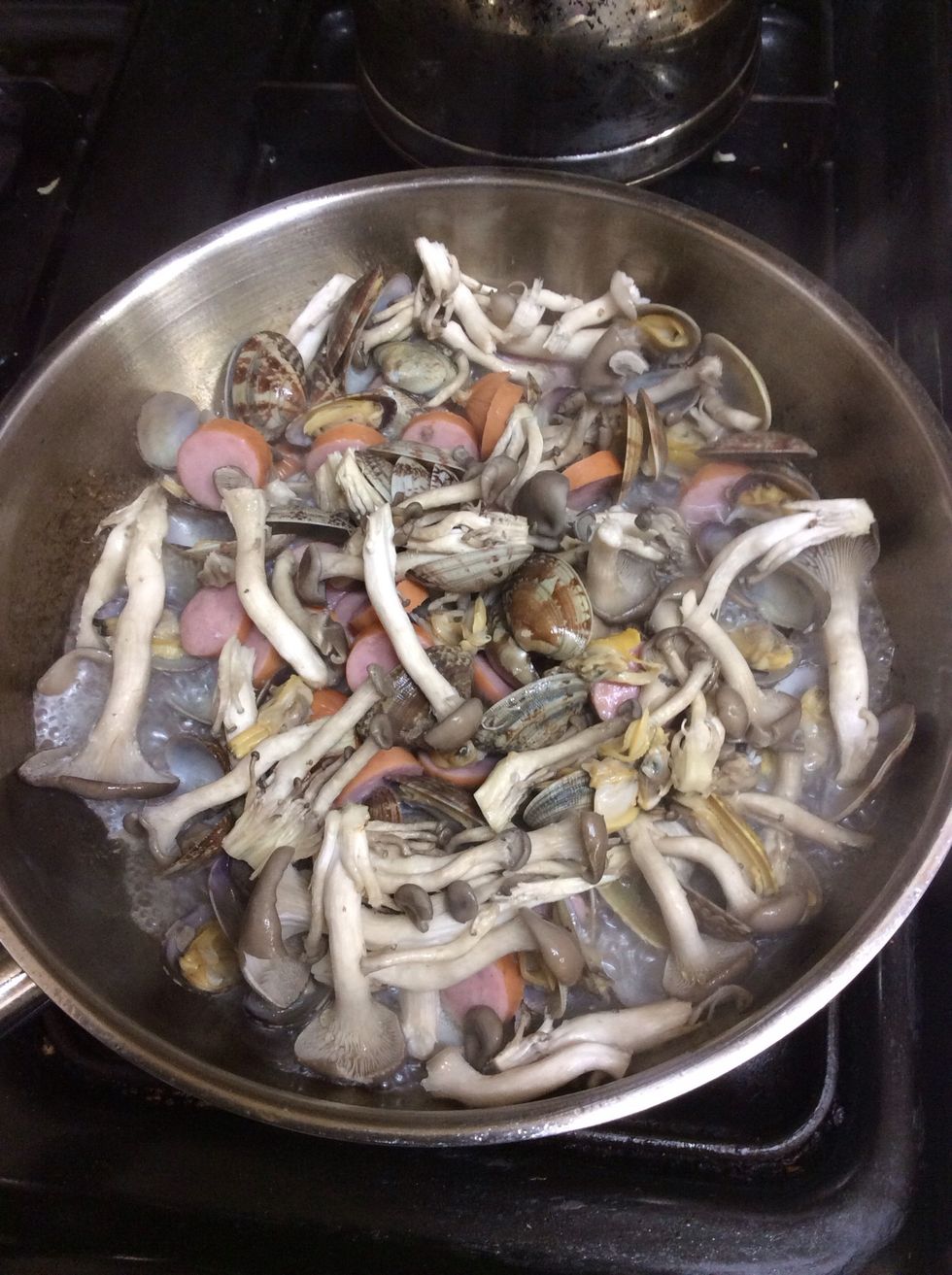 6. putting sausage slices and some mushroom in the pan