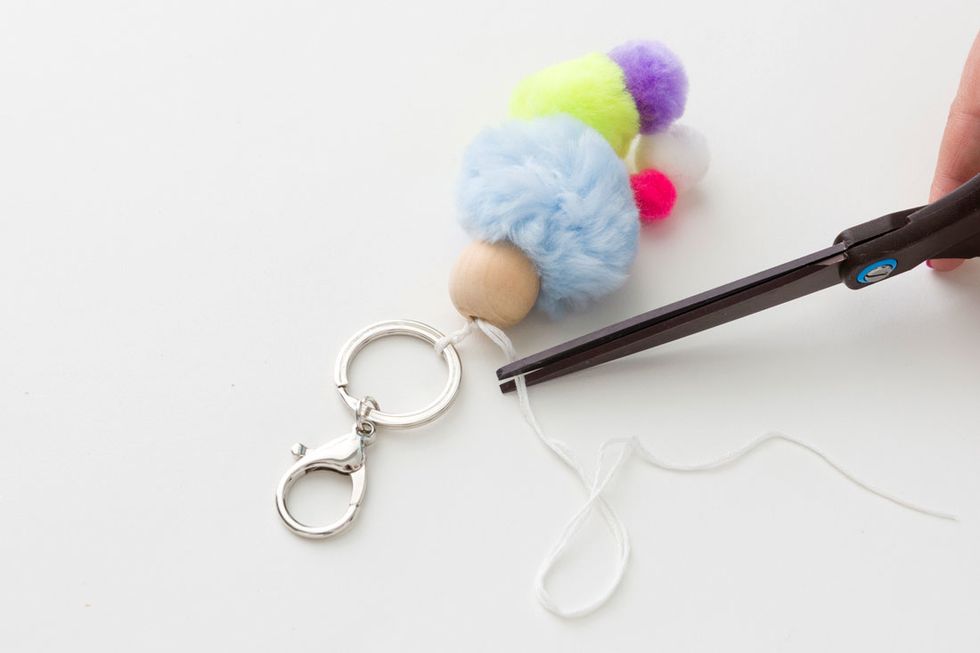 6. Trim the loose ends of thread with scissors and clip onto your backpack or keys!