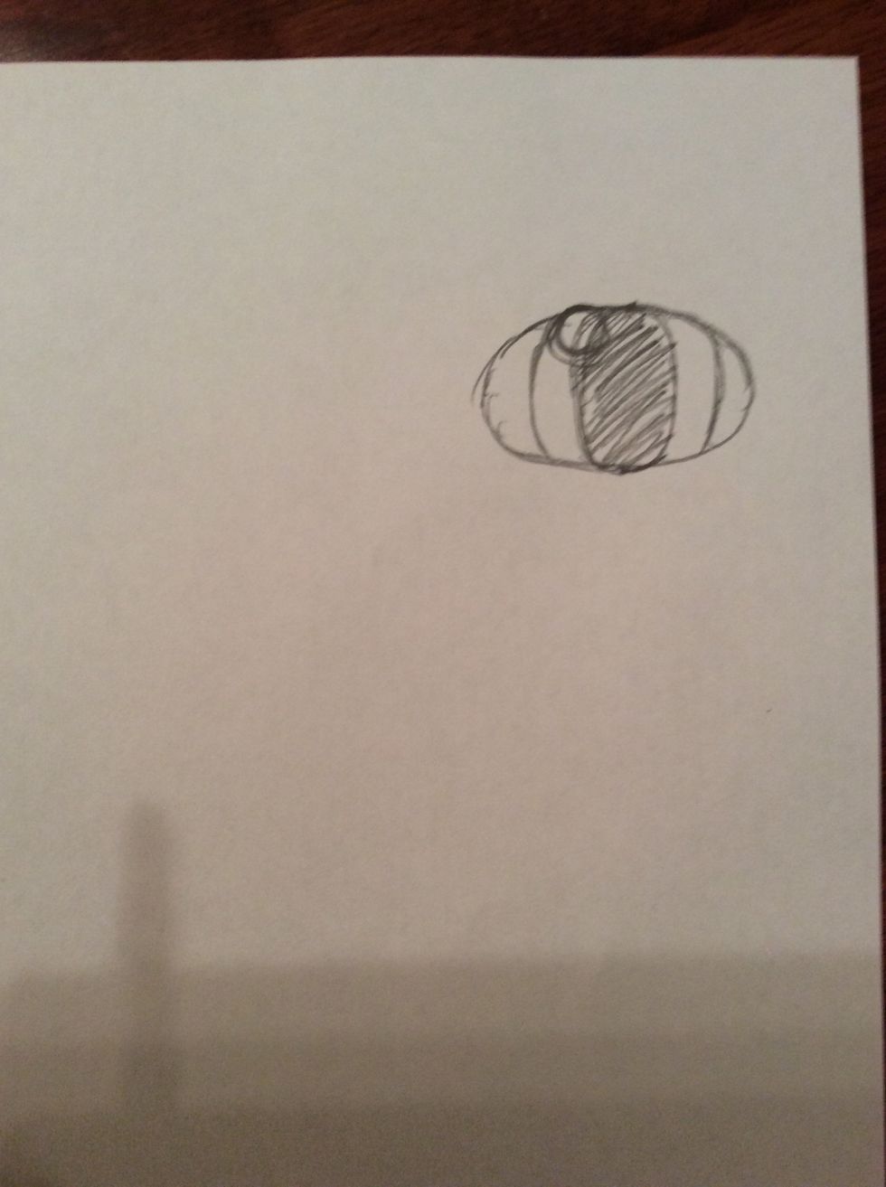 7. Draw a small circle, measuring 0.5cm in width, in between the two curved lines that were drawn in step 5 and overlapping the shaded oval.