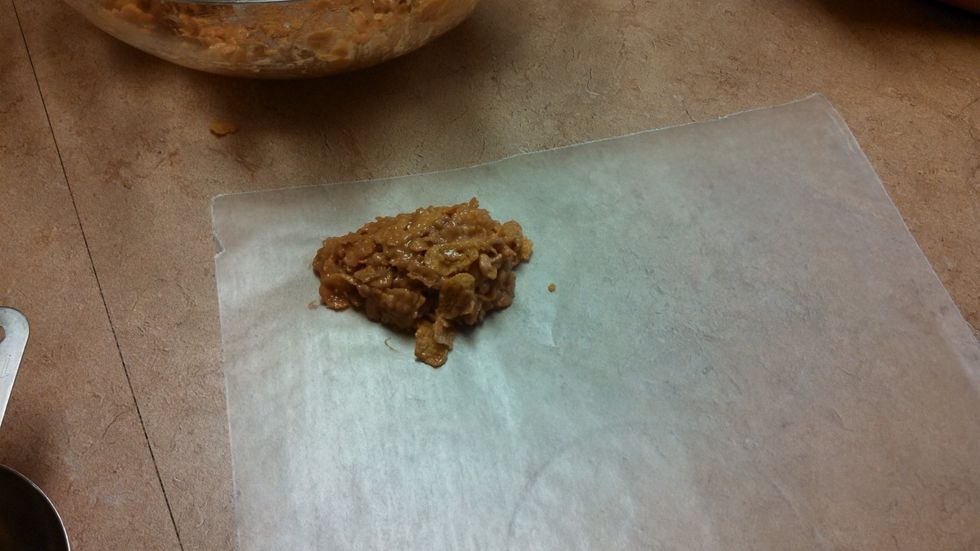 7. Then, take a spoon and scoop the desired amount onto a sheet of wax paper. If the clumps start to come apart, push them back together with two spoons.