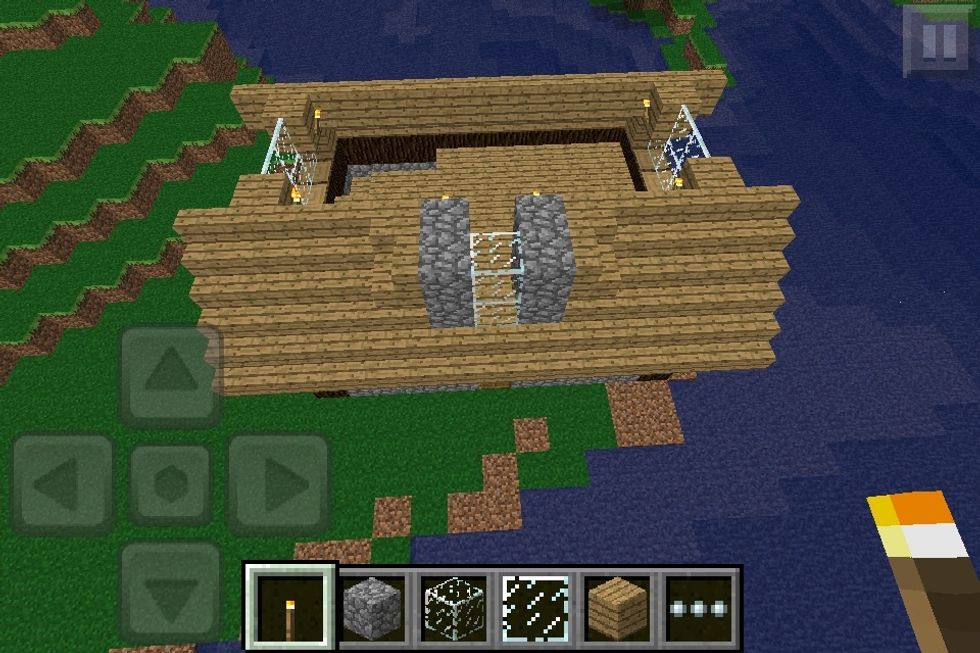 7th layer, add to the walls, roof, side and front windows. Make sure you do the stairs for the front window right, they're tricky. Add torches too!