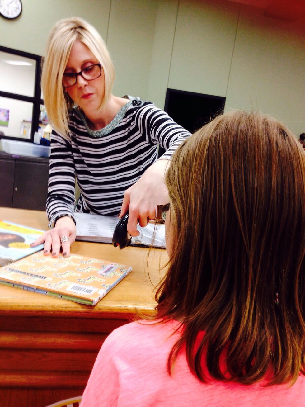 8. Now you may check out your book. You go to the check out desk and wait for an adult to help you.