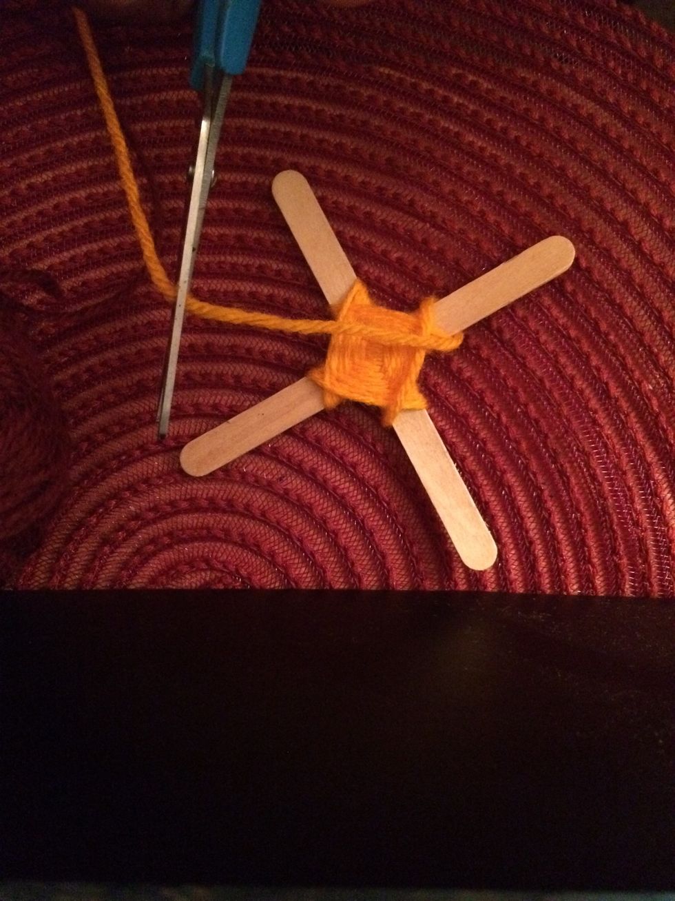9. Grab your scissors and cut your yarn...saving enough space to tie a knot.