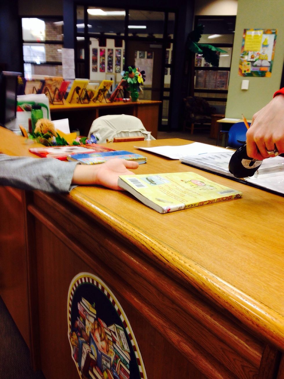 9. Once you are ready to check out take your books to the check out desk and ask the librarian to scan them.