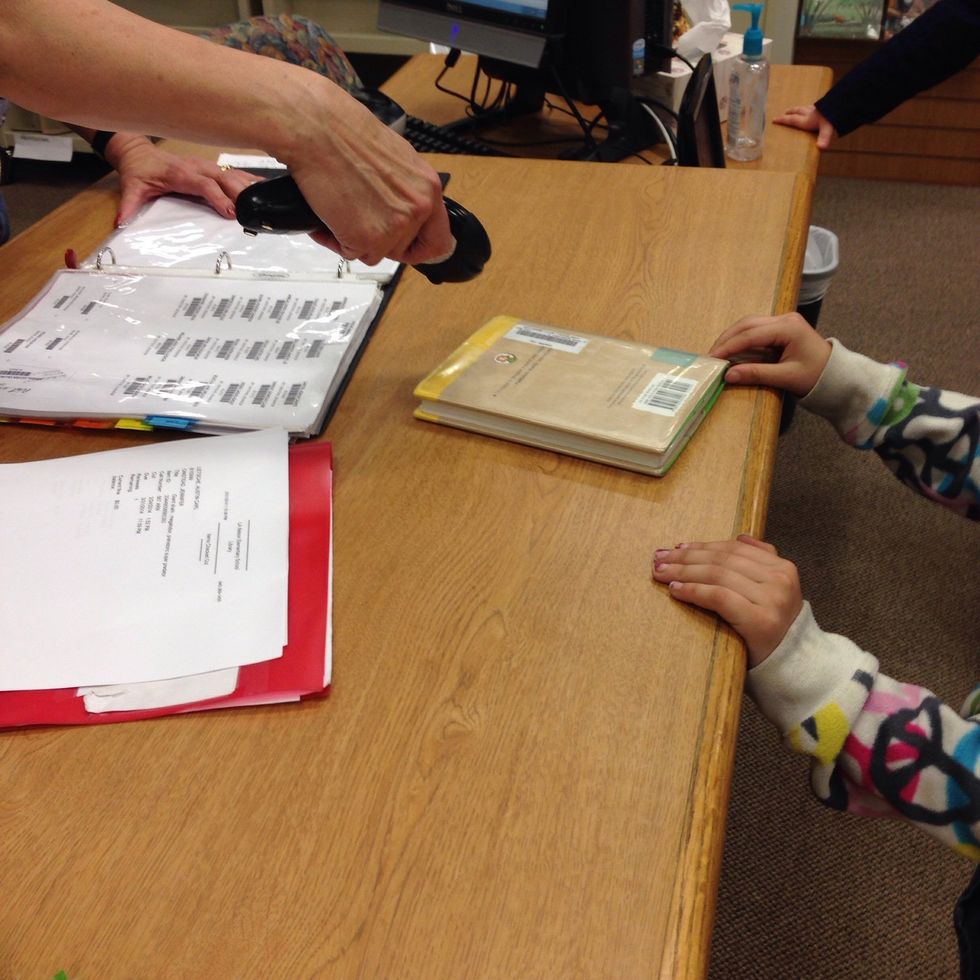 9. Once you have found a book that you like, you go to the circulation desk and wait for the librarian to scan your name and your book(s).