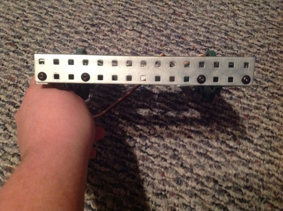 9. Take both Chassis Bumpers and add to both ends of the body as shown. Fasten using 4 Keps Nuts and 4 8-32 1/4" Screws on each side (8 of both in total).