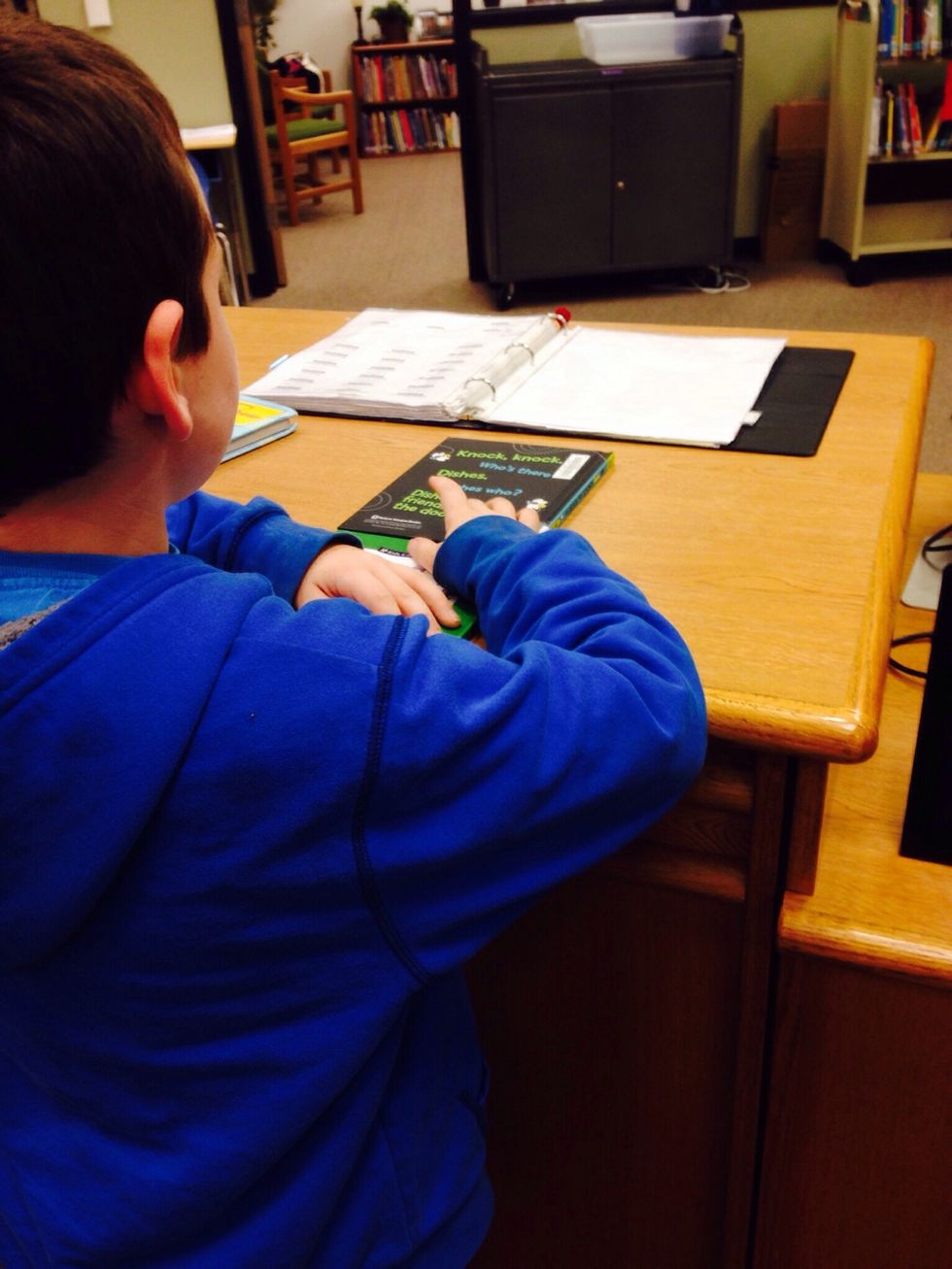 9. Tell the librarian your name, and he or she will scan your account. Then the librarian will scan the barcode on your library book.