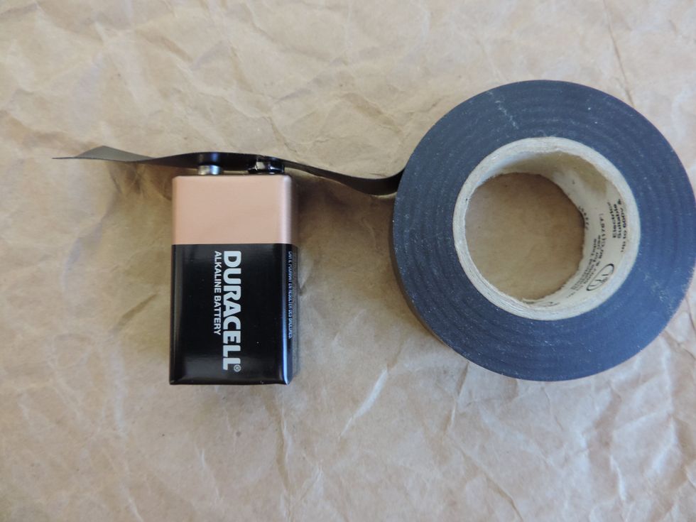 9V batteries are a little different as both the negative and positive ends are right next to each other. Measure out enough electrical tape to cover both ends and extend down the sides of the battery.
