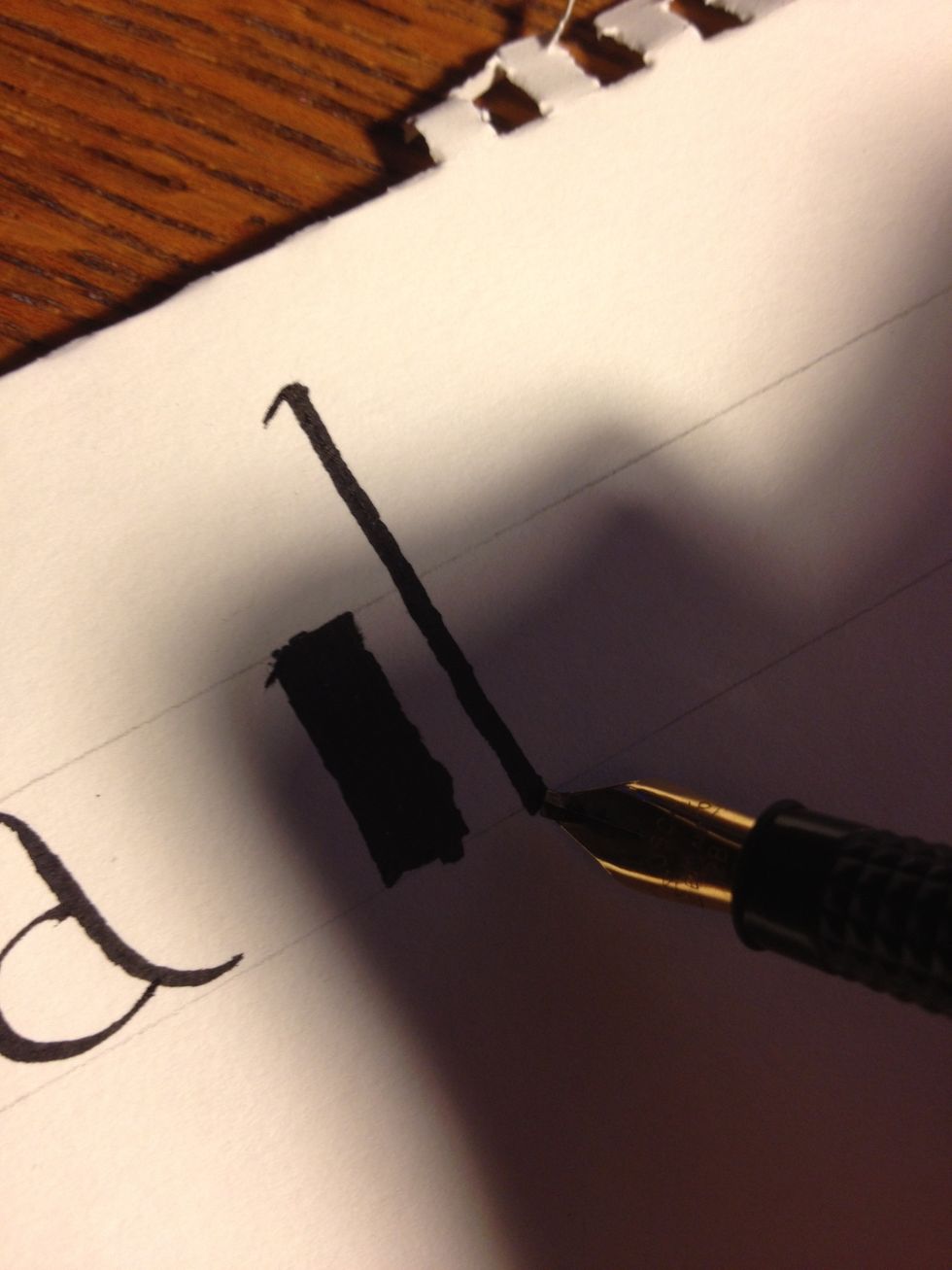 A basic minuscule "b"; ignore the block to the left of it, it's a "b" I wrote in the wrong size. Start well above the top line, with the nib angled 45 degrees down to the left. Make a trunk as shown.