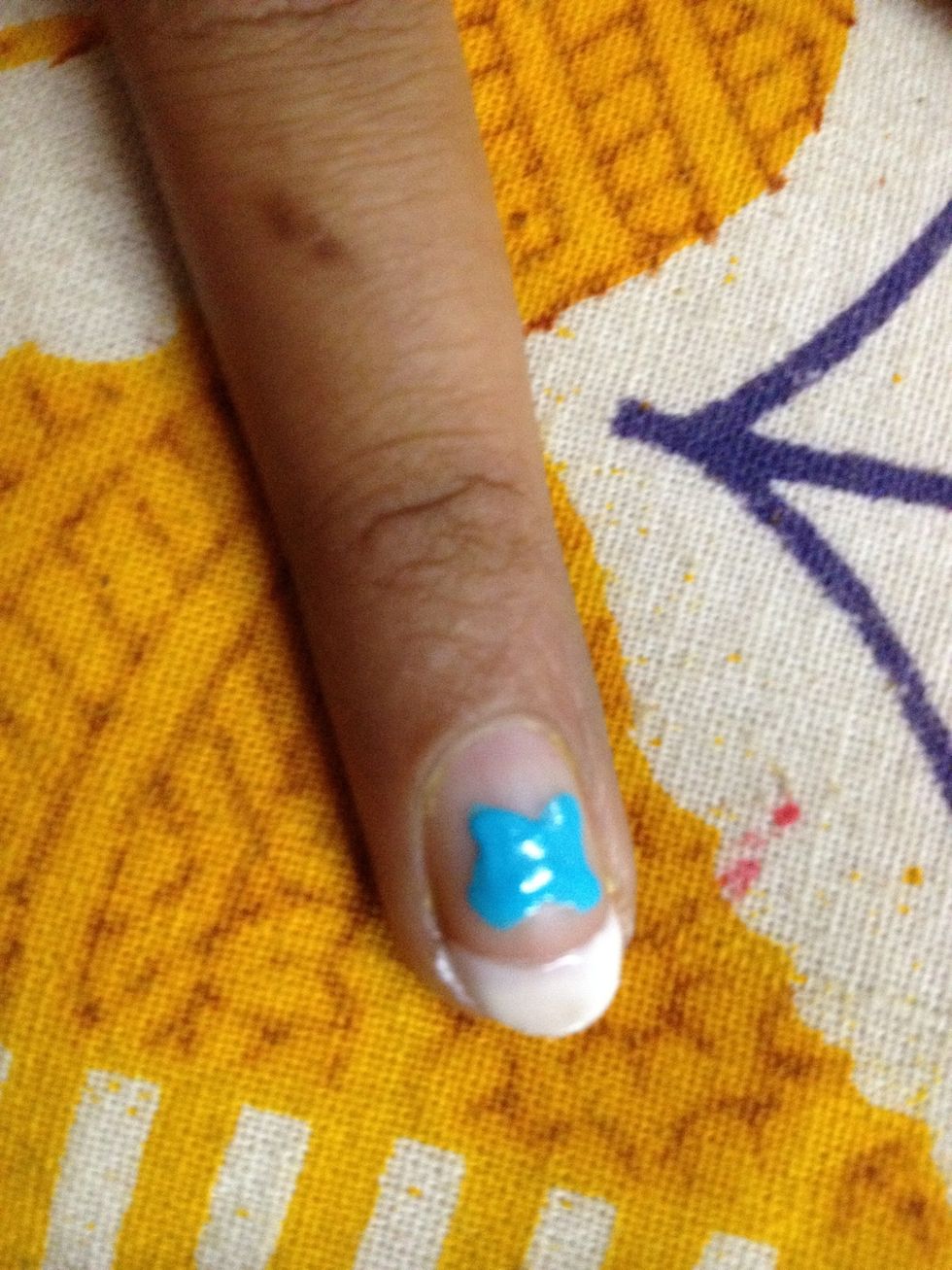 A blob of blue paint shaped like an 'x' ...