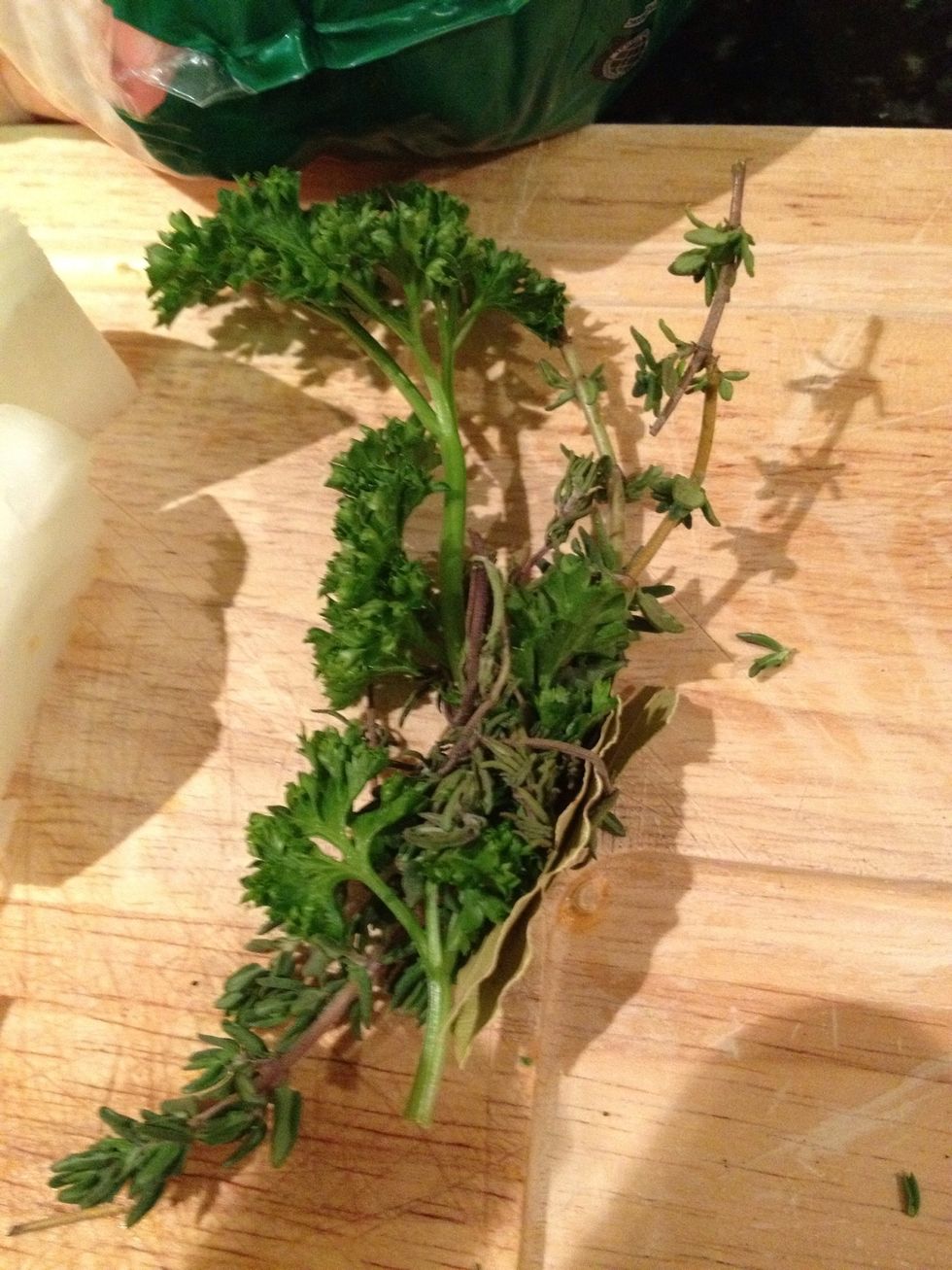 A bouquet garni is a mix of fresh thyme, parsley, bay leaf tied together so that it's easy to extract later.