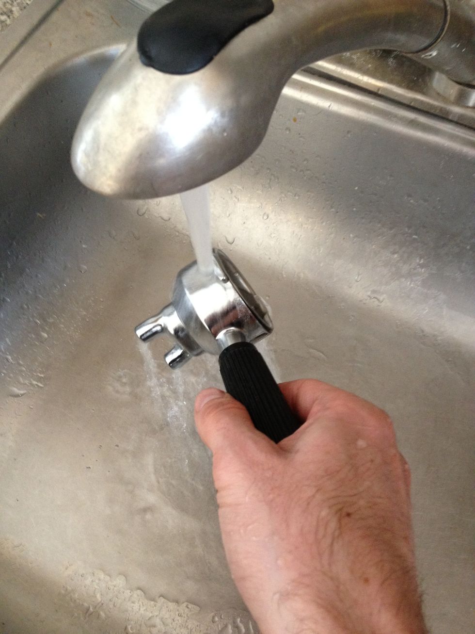 A cold portafilter makes a lousy first espresso. Heat it up for the first pull using hot water. Running it under a hot water tap works just fine. Or, do an empty pull (no coffee) on the machine.