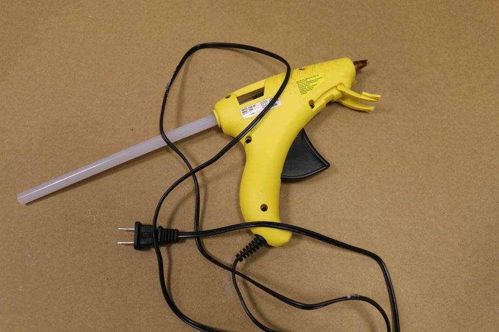 A hot glue gun and glue sticks