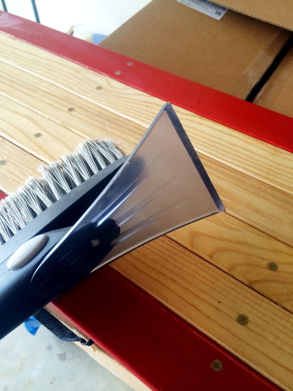 A ice scraper works just fine. They make ski and snowboard scrapers. Doesn't matter as long as you have a sharp flat edge to scrape the wax off.