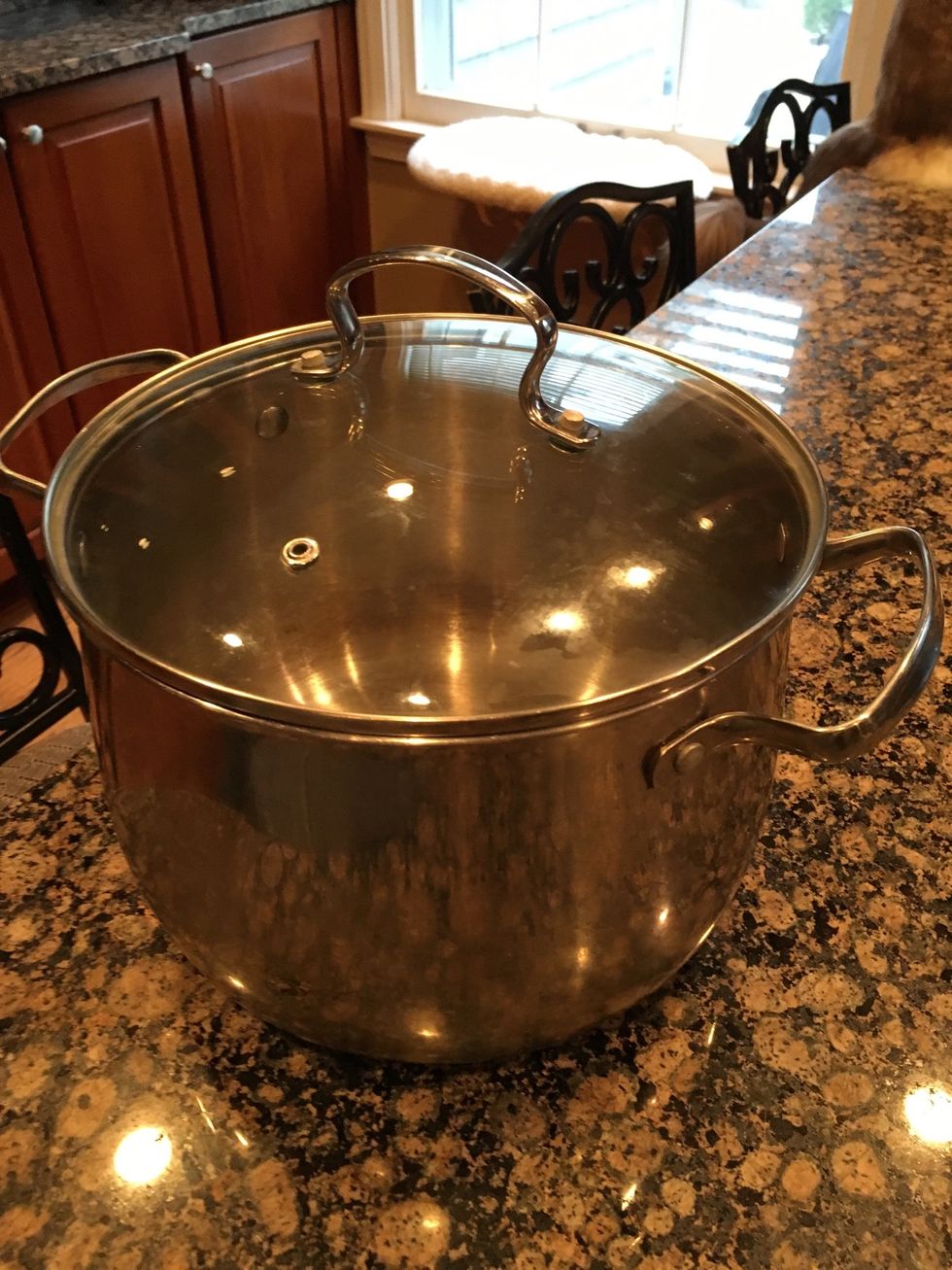 A large pot is used to cook large amounts of food such as corn on the cob or crab