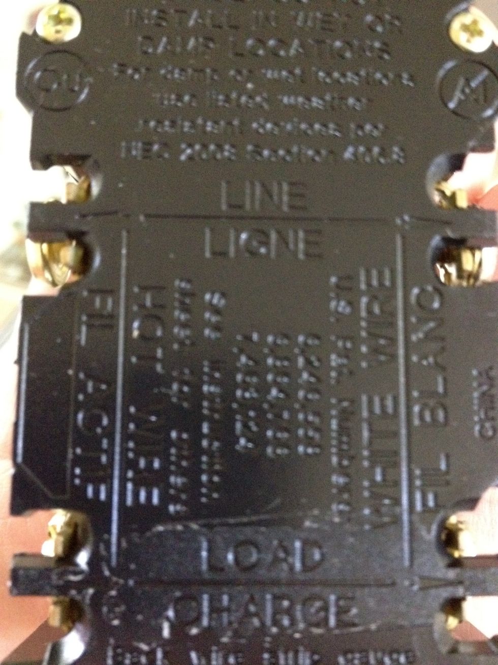 A little hard to read, but the left side says "hot wire" and the right side says "white wire". We'll put the black wires on the hot side and the white wires on the left side.