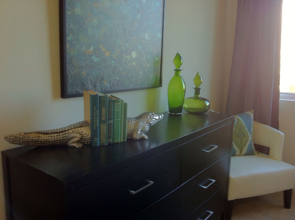 A low profile dresser topped with a nice piece of art, a lamp and some books is all you need.