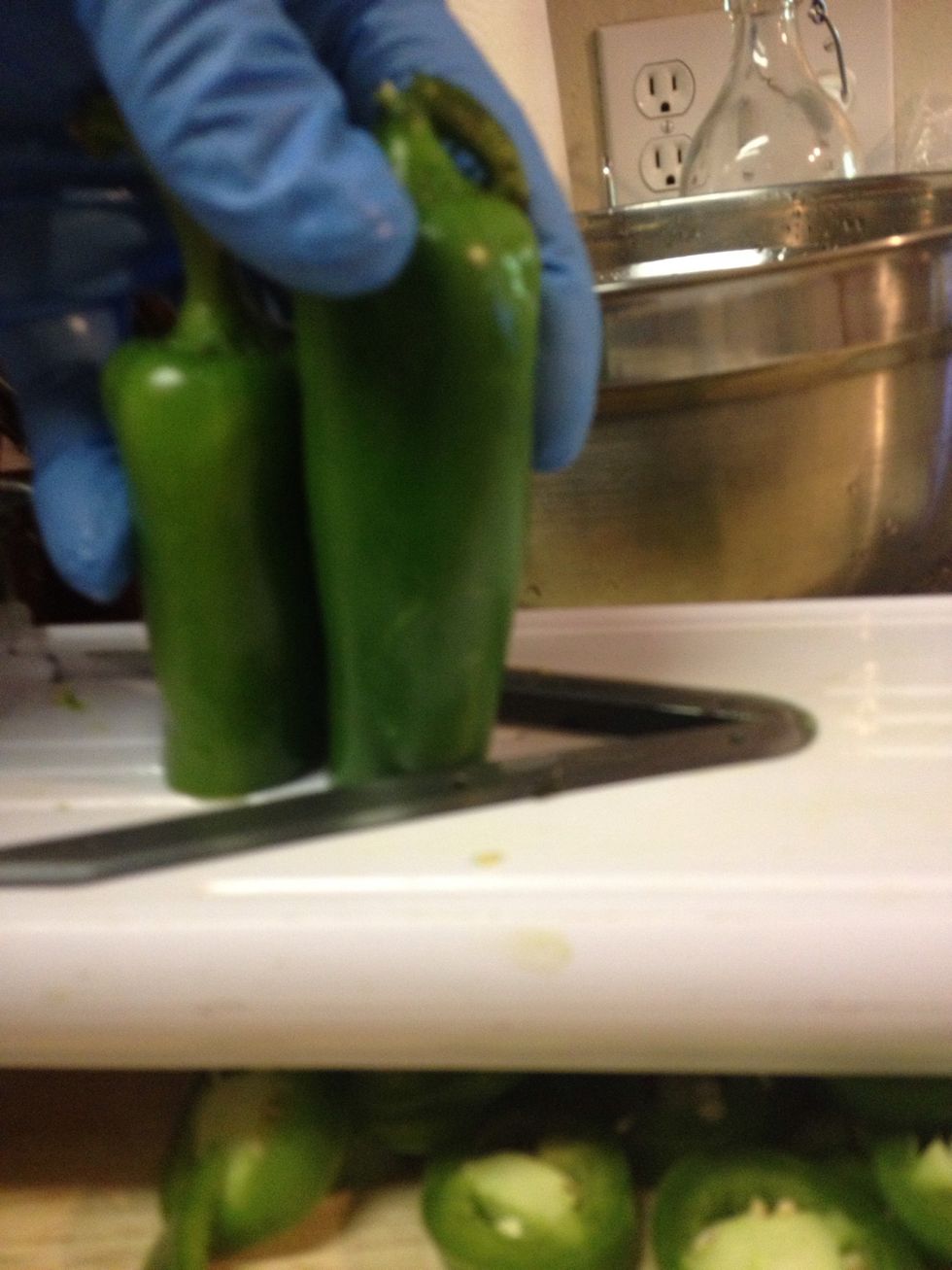 A mandolin helps to get even slices.         Gloves help to prevent your skin and eyes burning from the capsaicin in the peppers.