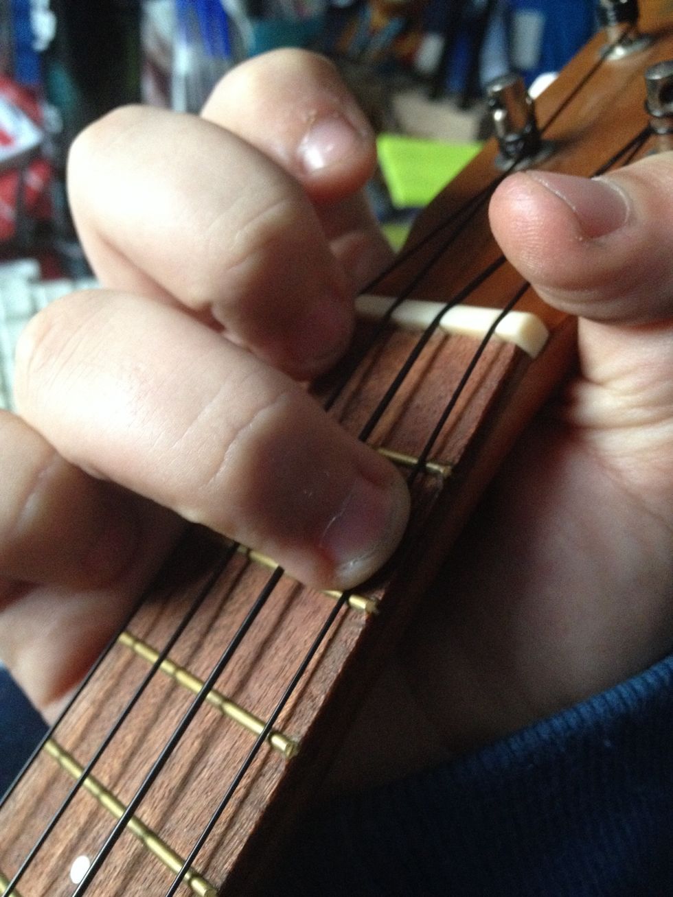 A minor chord. 4th string, 2nd fret.