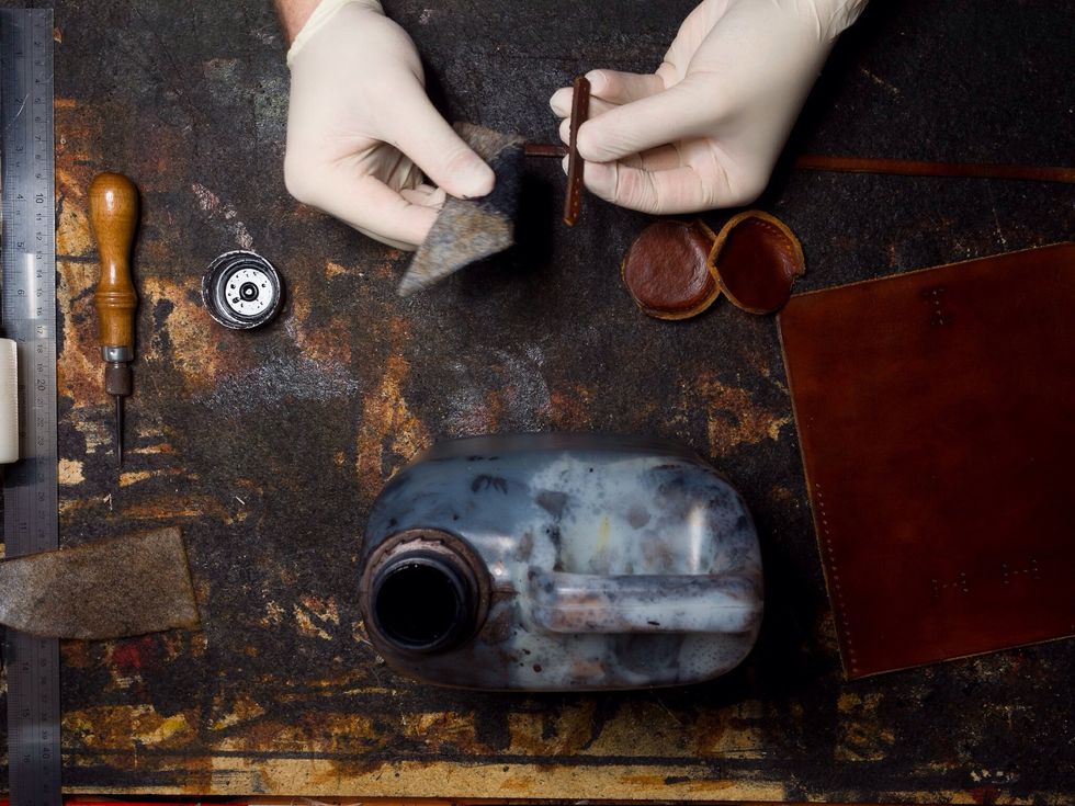 A piece of felt is an easy way to dye the edges black without getting the colour all over the rest of the leather.