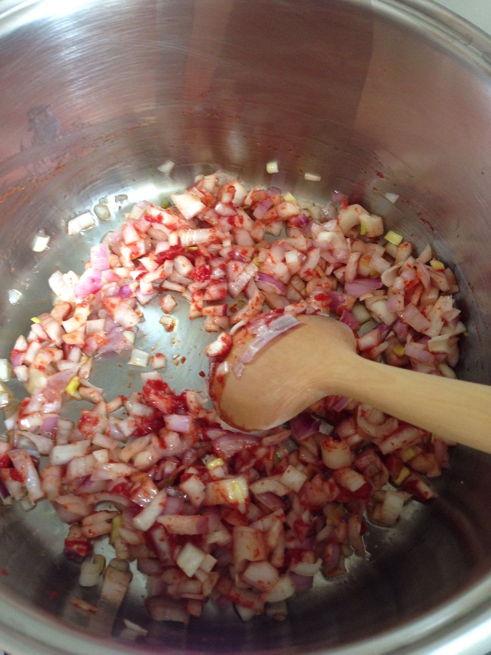 A piece of oil and chopped onions and tomato paste was cooked.