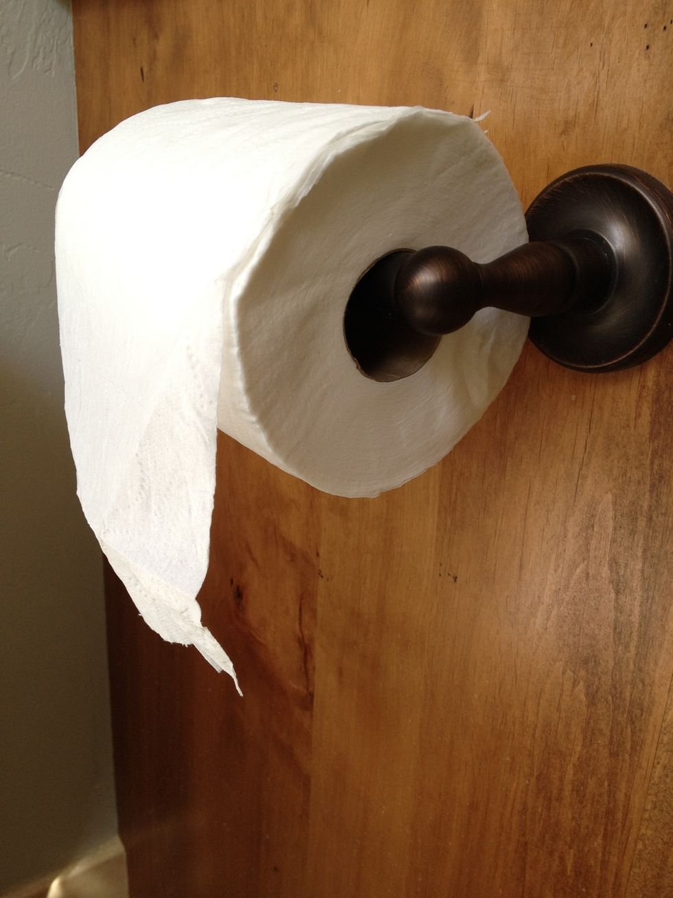 A properly installed roll will always come over the top and unroll in the front, not the back. This is a crucial part of TP etiquette. Having it unroll toward the back is very inefficient!