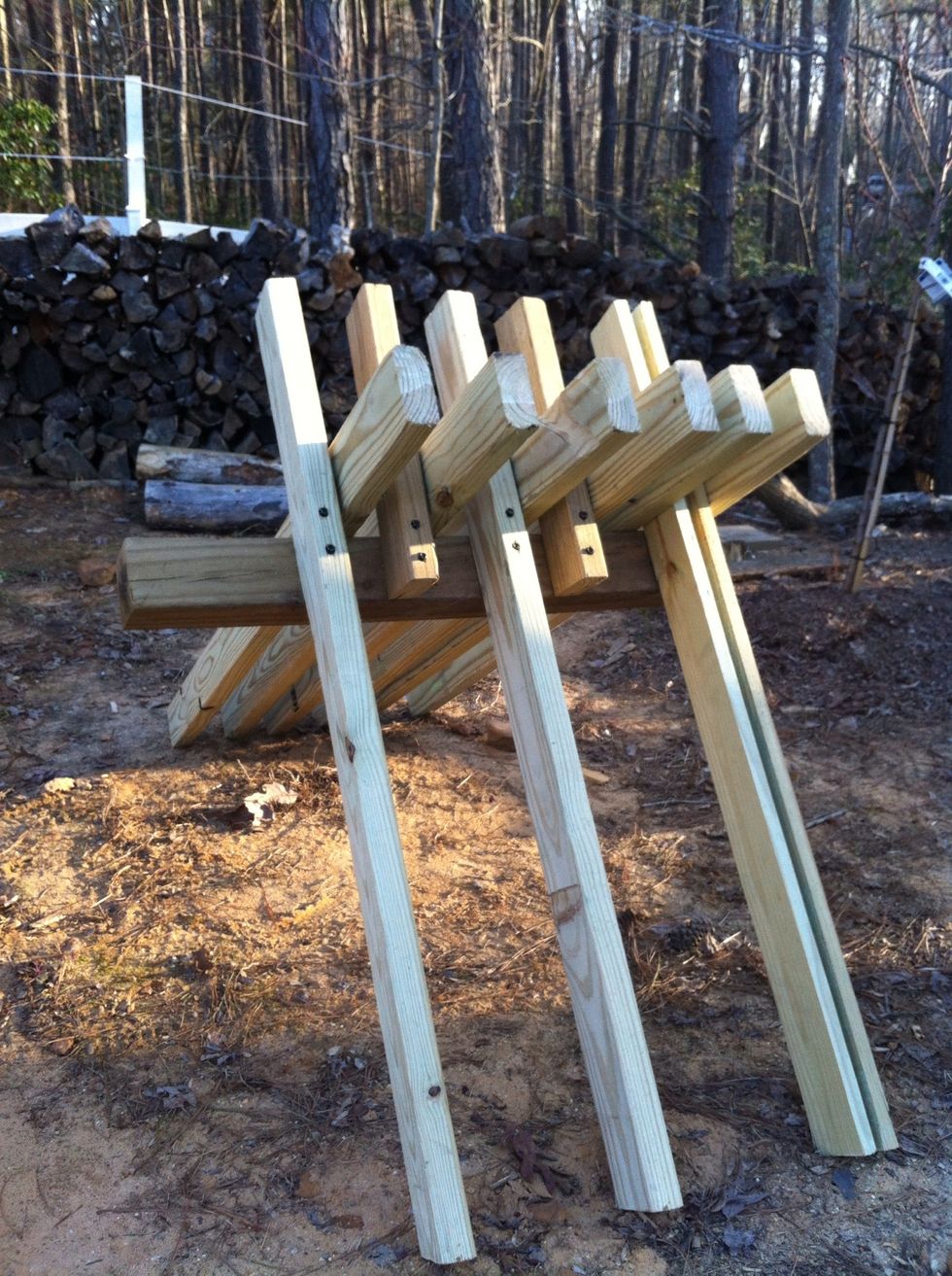 A sawbuck lets you make fast cross-cuts. The first step is to cut split, seasoned wood into 1' lengths.