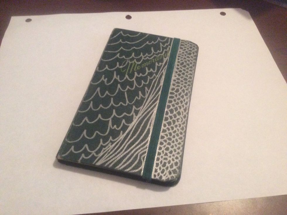A small notebook and I drew and added the elastic to it