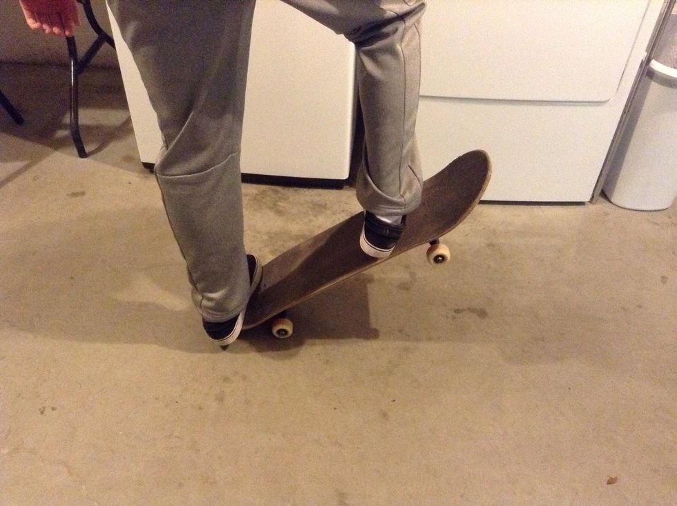 A split second after you pop your tail on the ground slide your front foot up the board dragging your shoe to make the board ollie.