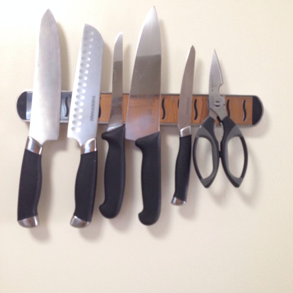 A stainless steel magnetic bar not only makes space for your tools but also is a sure way to keep sharp things out of your kid's reach. This is a miu france magnetic bar 15 inches available @ amazon.