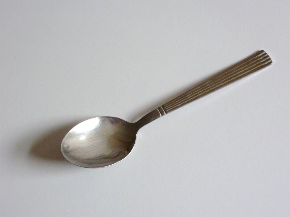 A teaspoon and a table to get your ingredients and requirements together so you can make your homemade iced coffee.