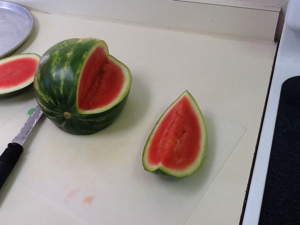 About 3/4 inch from the middle cut straight down till the cut reaches what would be the middle if it were whole. Then cut horizontally till you reach the other cut going down.