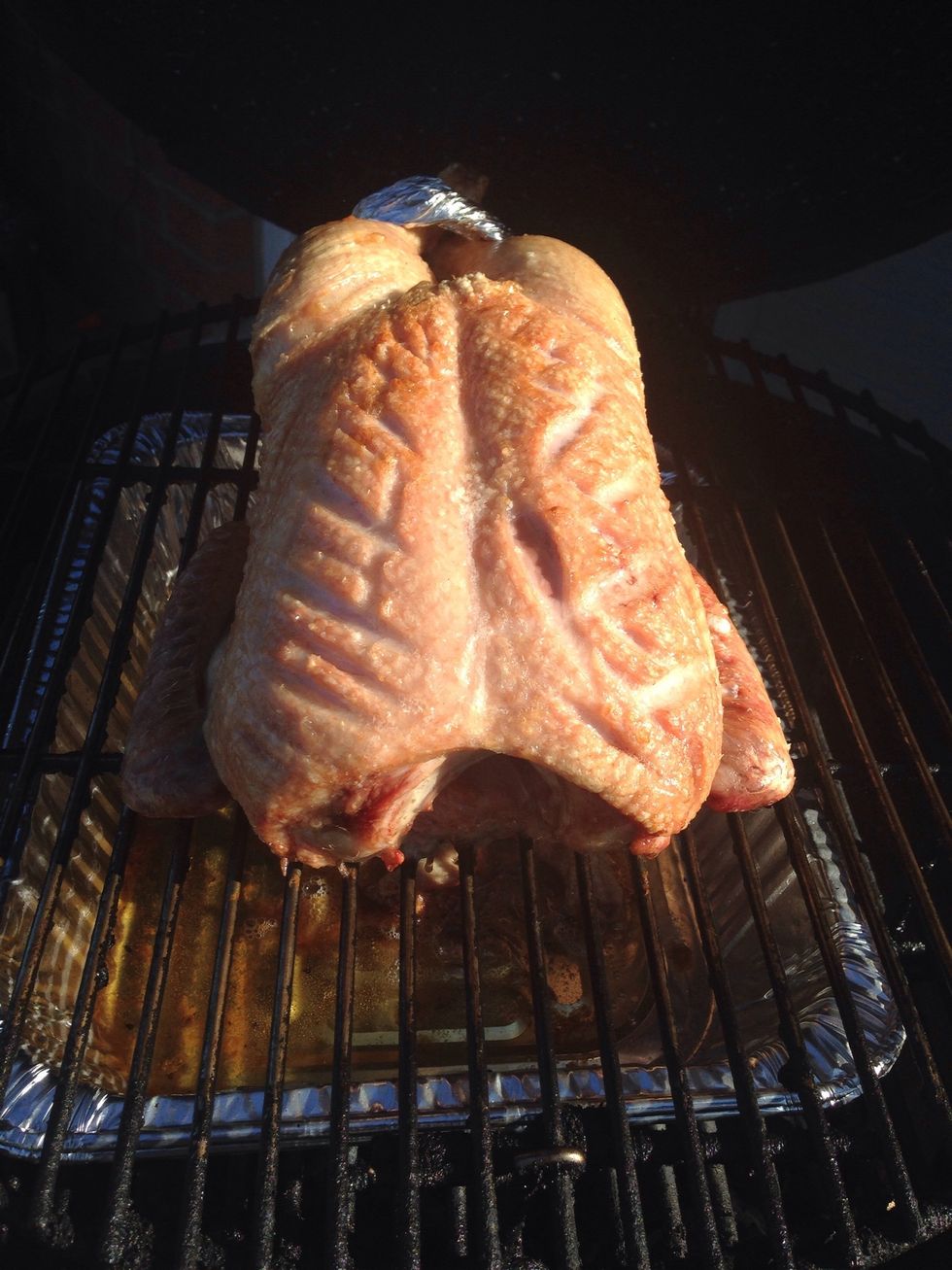 About 45 minutes later, already smelling incredible out here. At this point you want to pierce the skin with the tip of a sharp knife and flip it over.