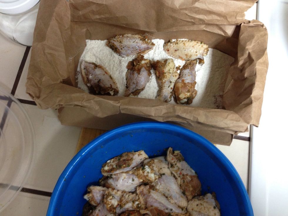 About 5 or 6 at a time. shake the bag and use a clap to shake the excess flour