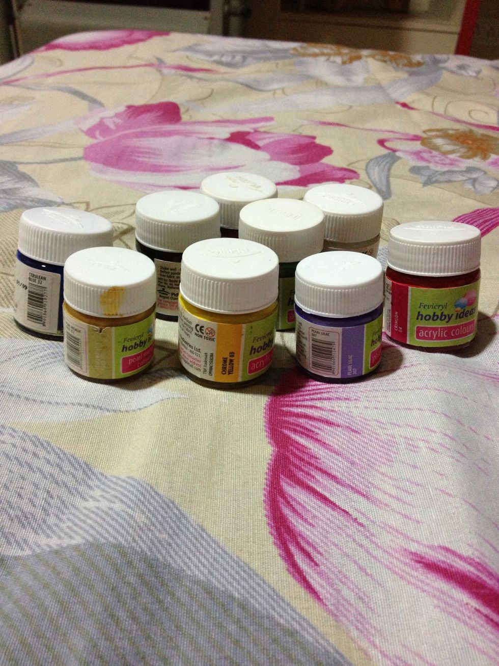 Acrylic paints. I am using purple on the flowers and yellow on the background.