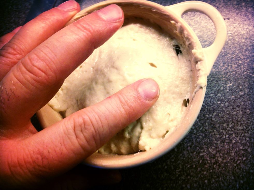 Ad the dough with a spoon and even out with cold water on your finger.