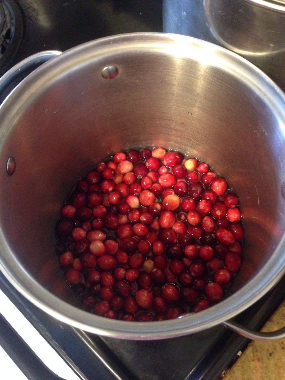 Add 1 (12oz) bag of fresh cranberries, picking out any bad looking ones, and 1 1/2 cups of water.