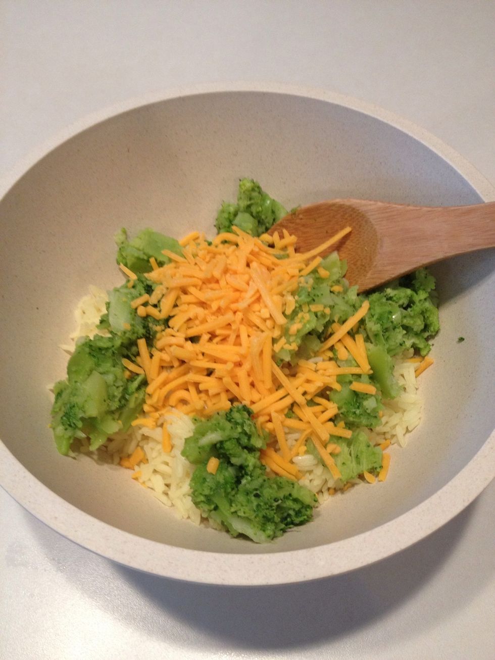 Add 1/2 cup of cheddar cheese to rice bowl. You will use the rest of the cheese later.
