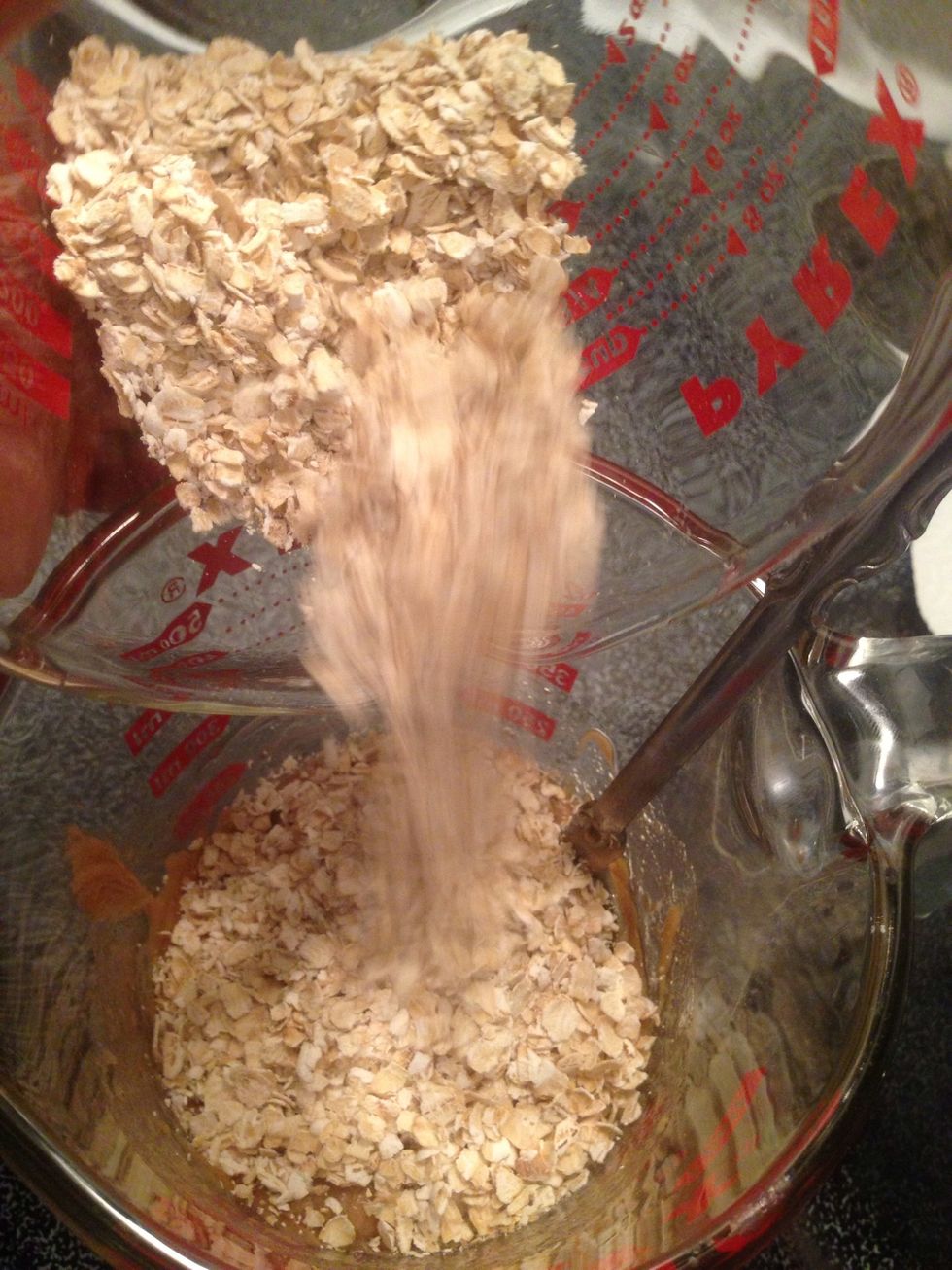 Add 1/2 cup of gluten free rolled oats to peanut butter mixture. Stir together.
