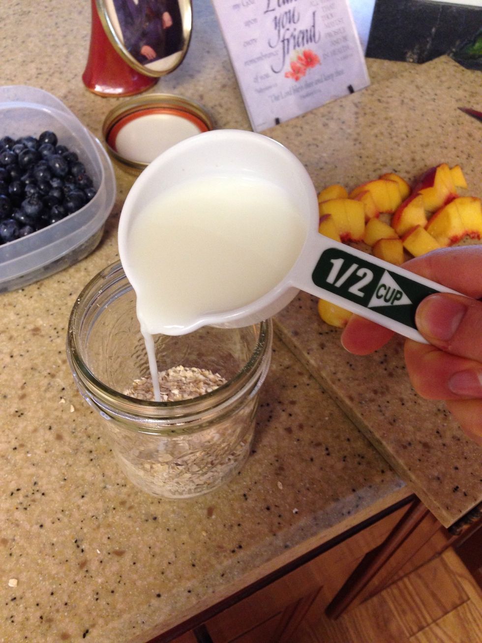 Add 1/2 cup of milk to mason jar.